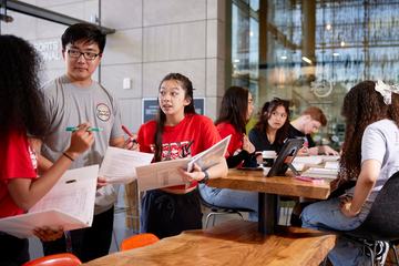 Students comparing papers